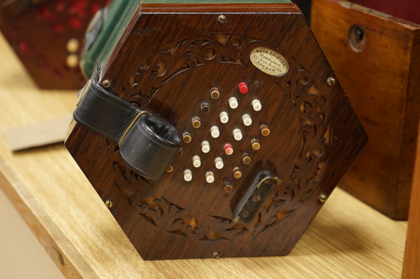 A mahogany cased concertina by Rock Chidley, 135, High Holborn, London, with the rosewood body and numbered 566, CITES Submission reference QML3VKXT